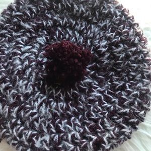 Knitted purple and white streaked hat